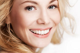 a woman smiling with white teeth