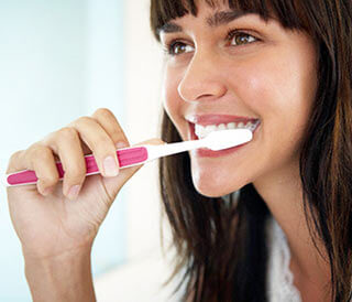 woman brushing her teeth