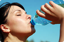 woman drinking bottled water