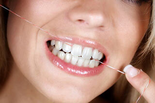 woman flossing her teeth